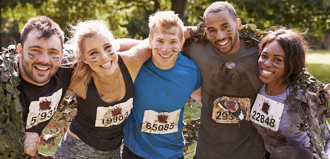 People smiling together after completing a mud run