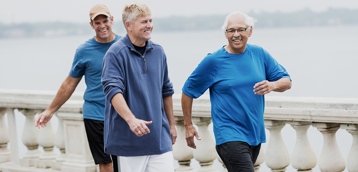 Three men walking together outdoors